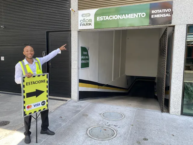 Colaborador Atlas Park indicando a entrada do estacionamento